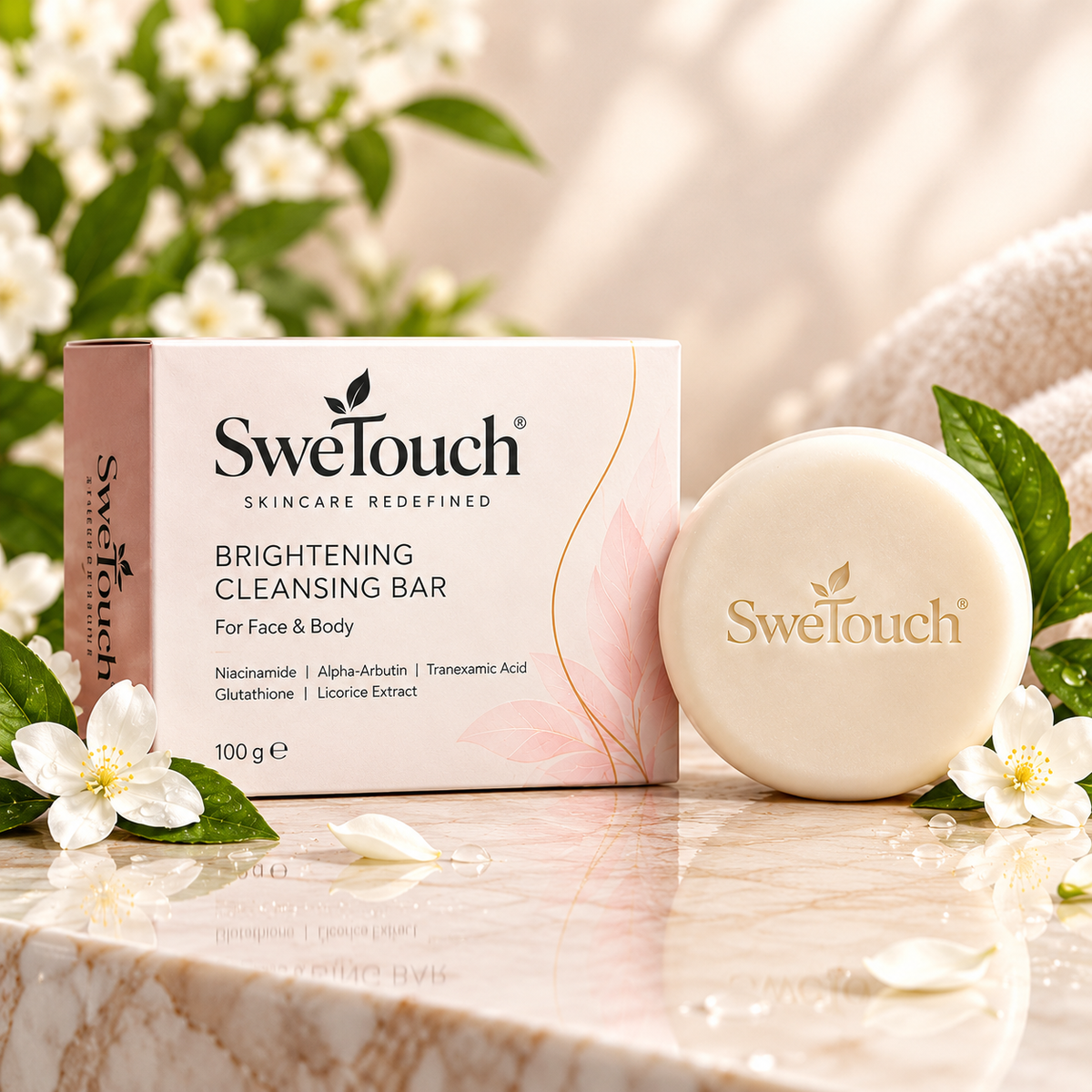 SweTouch Brightening Cleansing Bar soap bar next to its pink and white packaging box, styled with white flowers and green leaves on a marble surface.